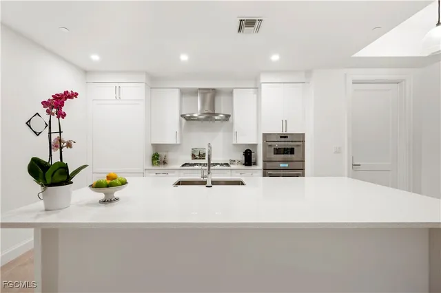 a kitchen with a sink and appliances
