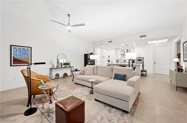 a living room with furniture and kitchen view