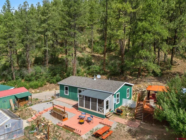 an aerial view of a house with swimming pool and sitting area