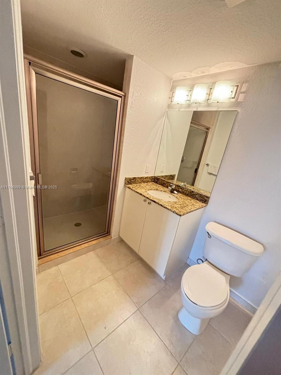 1830 Radius Drive, Unit 604 Hollywood, FL 33020 - Photo 11 of 22 a bathroom with a toilet and a shower