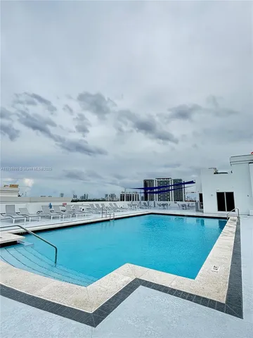 a view of a swimming pool and a yard
