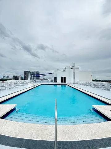 a view of a house with a big yard and large trees
