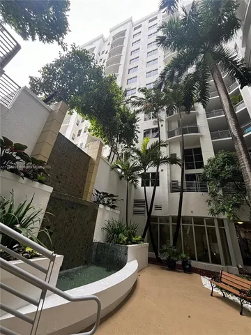 a view of roof deck with table and chairs and potted plants