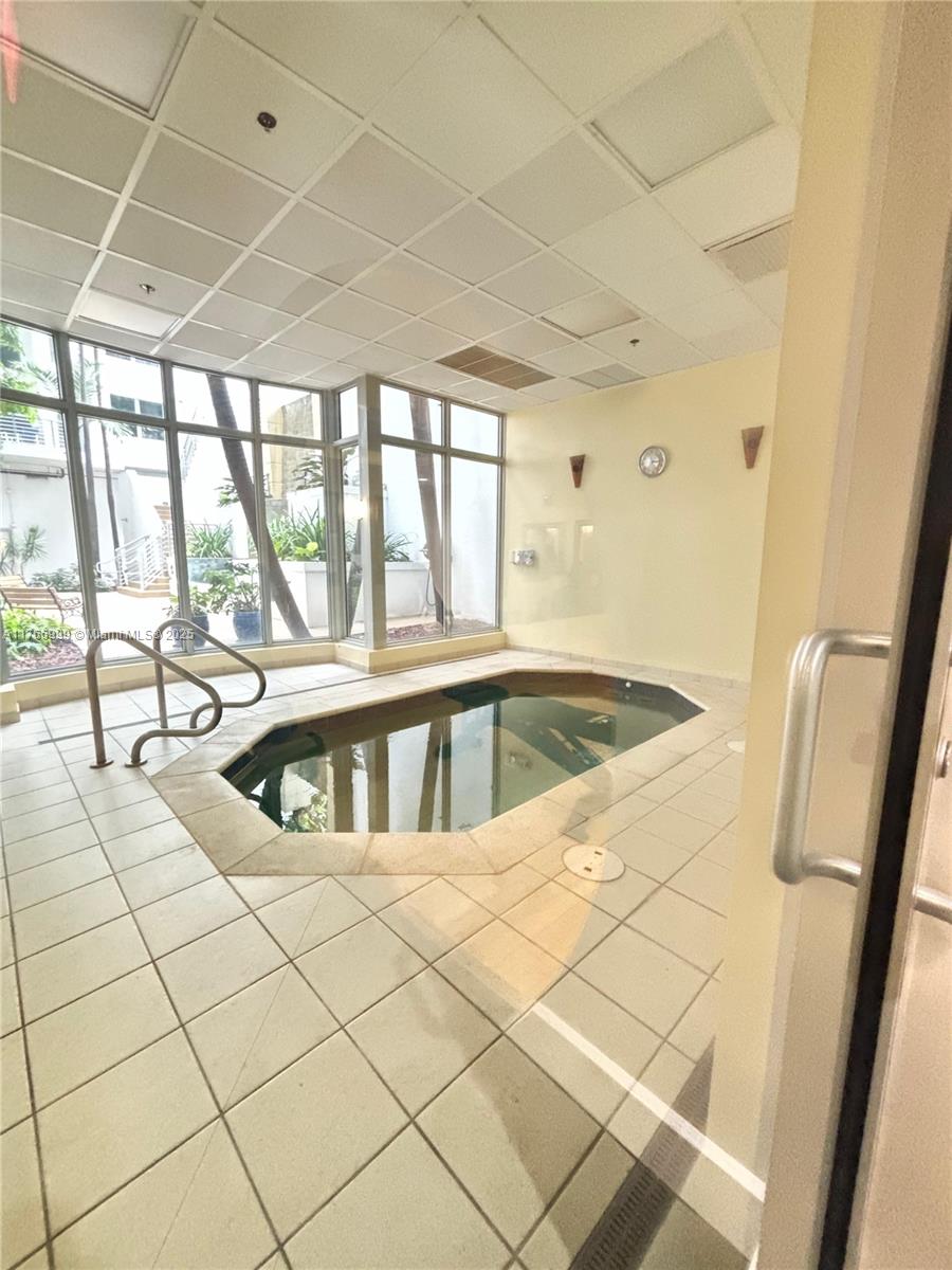 1830 Radius Drive, Unit 604 Hollywood, FL 33020 - Photo 22 of 22 a view of a bathroom with a sink a faucet a mirror and a shower