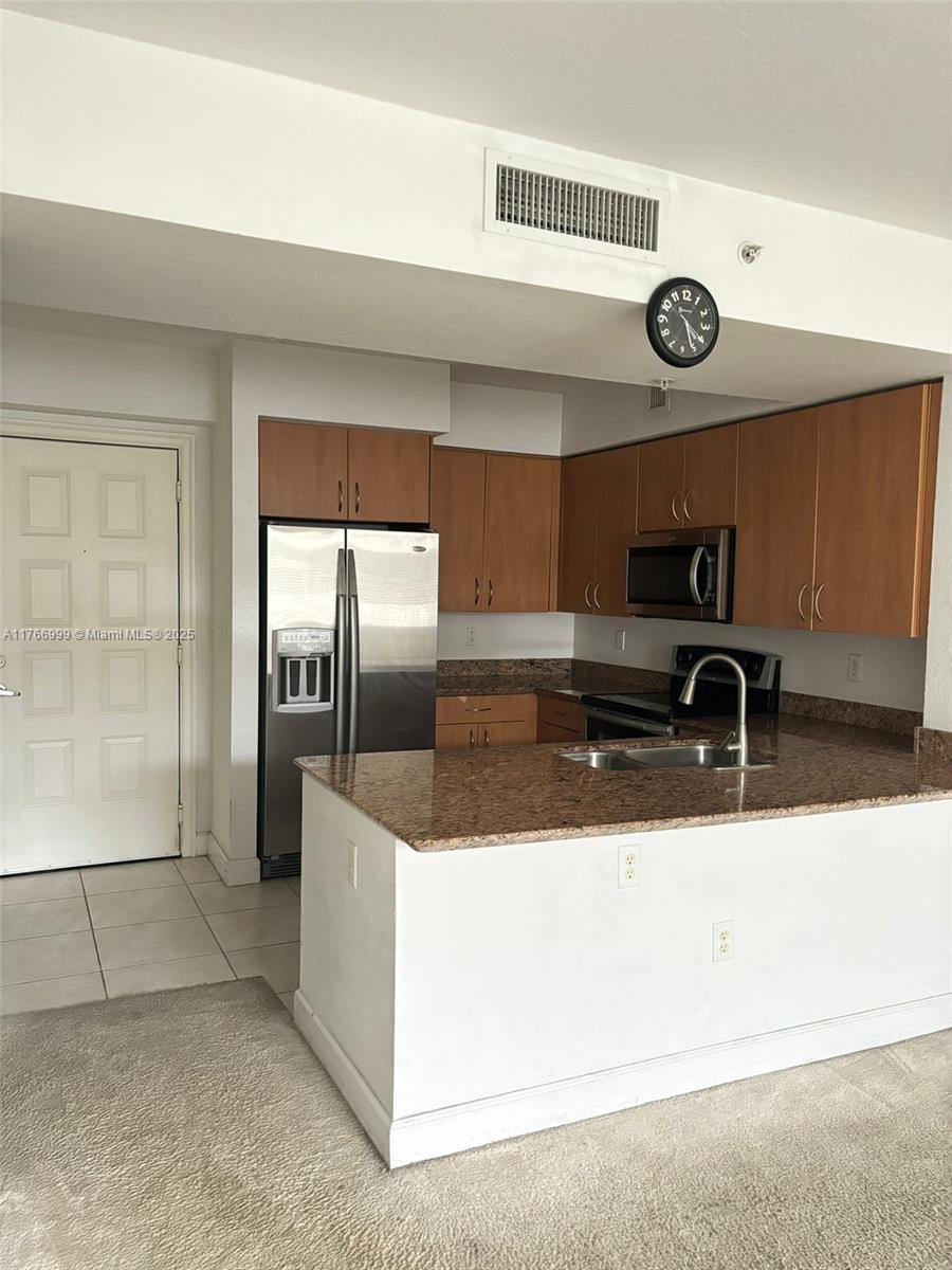 1830 Radius Drive, Unit 604 Hollywood, FL 33020 - Photo 5 of 22 a view of a refrigerator a sink and dishwasher