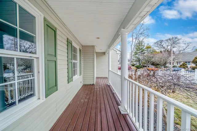 a view of a balcony with wooden floor