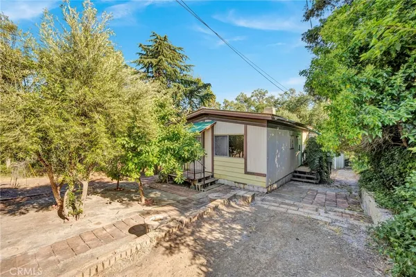 a view of a house with a tree in the background