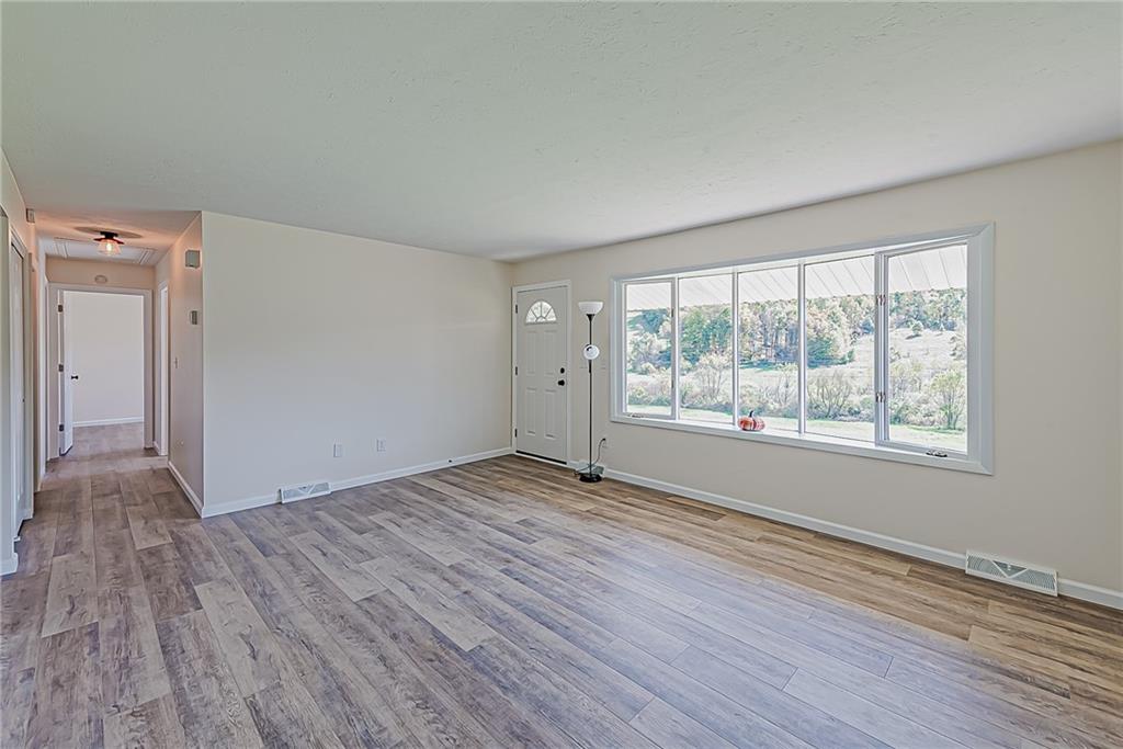510 Crooks Road Home, PA 15747 - Photo 6 of 20 a view of an empty room with wooden floor and a window