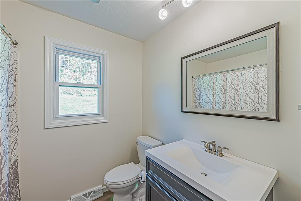 510 Crooks Road Home, PA 15747 - Photo 8 of 20 a bathroom with a sink mirror and toilet