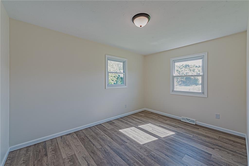 510 Crooks Road Home, PA 15747 - Photo 10 of 20 wooden floor in an empty room with a window