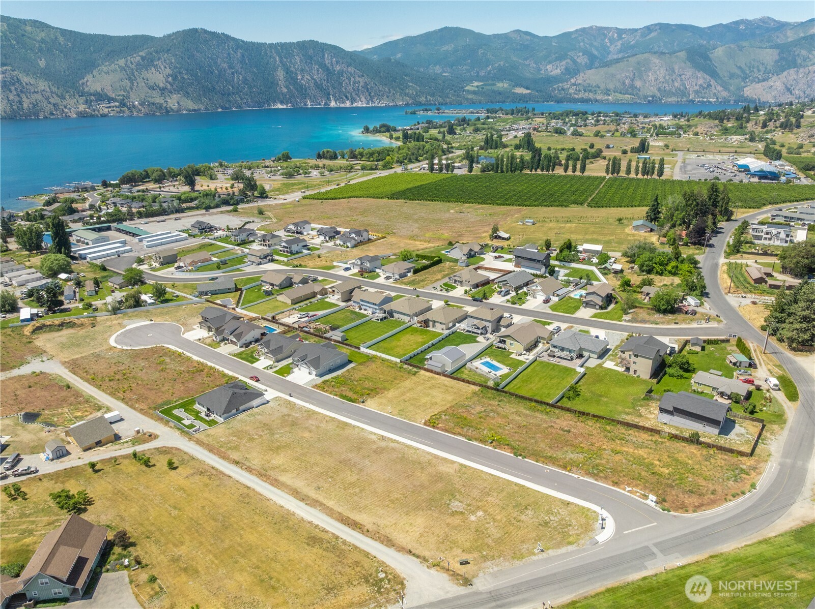 58 Sailing Hawk Lane Manson, WA 98831 - Photo 21 of 36 an aerial view of residential houses with outdoor space and river