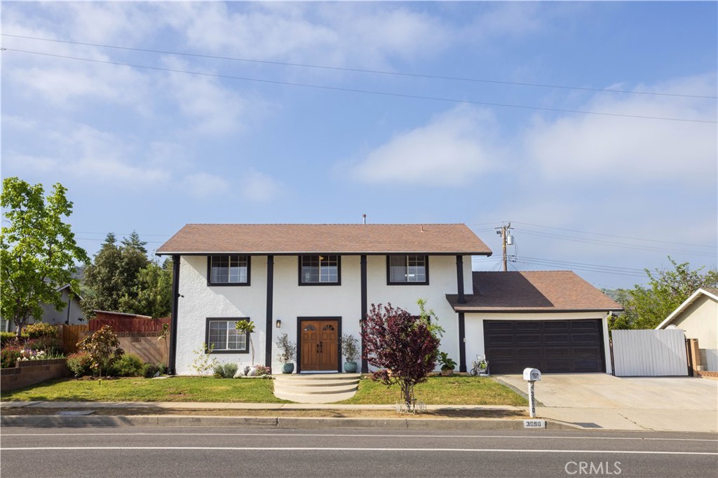 3090 Fitzgerald Road Simi Valley, CA 93065 - Photo 1 of 1 a front view of a house with a yard and garage