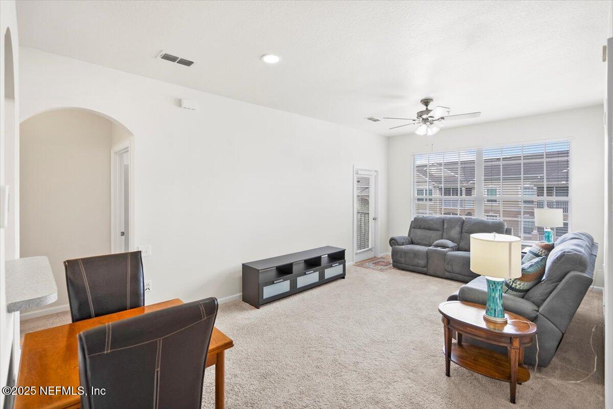 7990 Baymeadows Road, Unit 327 Jacksonville, FL 32256 - Photo 8 of 36 a living room with furniture and a flat screen tv