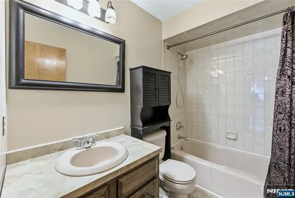 a bathroom with a sink toilet tub and shower