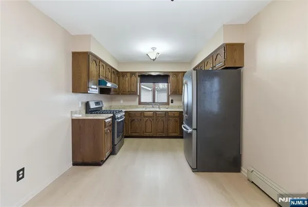 a kitchen with stainless steel appliances a refrigerator and a sink
