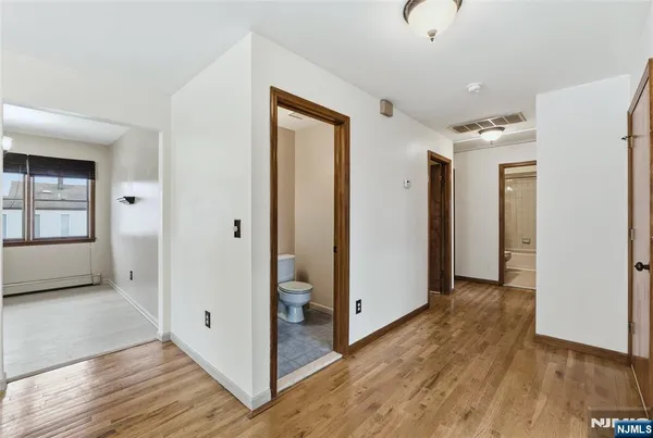 a view of hallway with wooden floor
