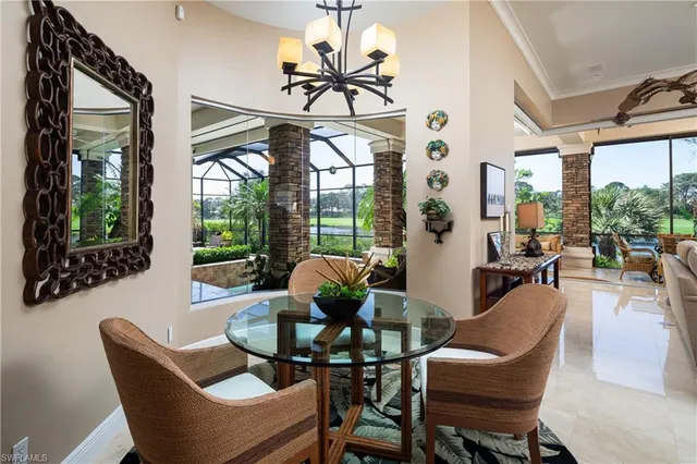 a dining room with furniture a chandelier and a rug