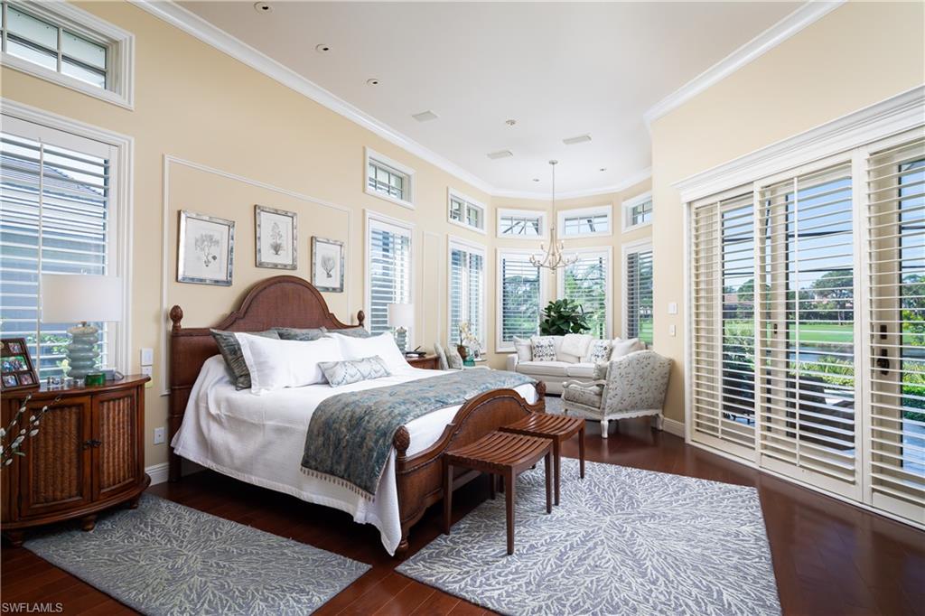 980 Barcarmil Way Naples, FL 34110 - Photo 16 of 50 a bedroom with a bed and wooden floor