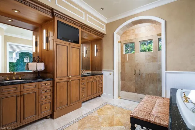 a spacious bathroom with a granite countertop sink a mirror and shower