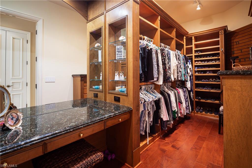 980 Barcarmil Way Naples, FL 34110 - Photo 19 of 50 a view of walk in closet with clothes and shoes