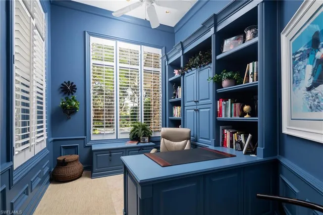 a living room with furniture and a book shelf