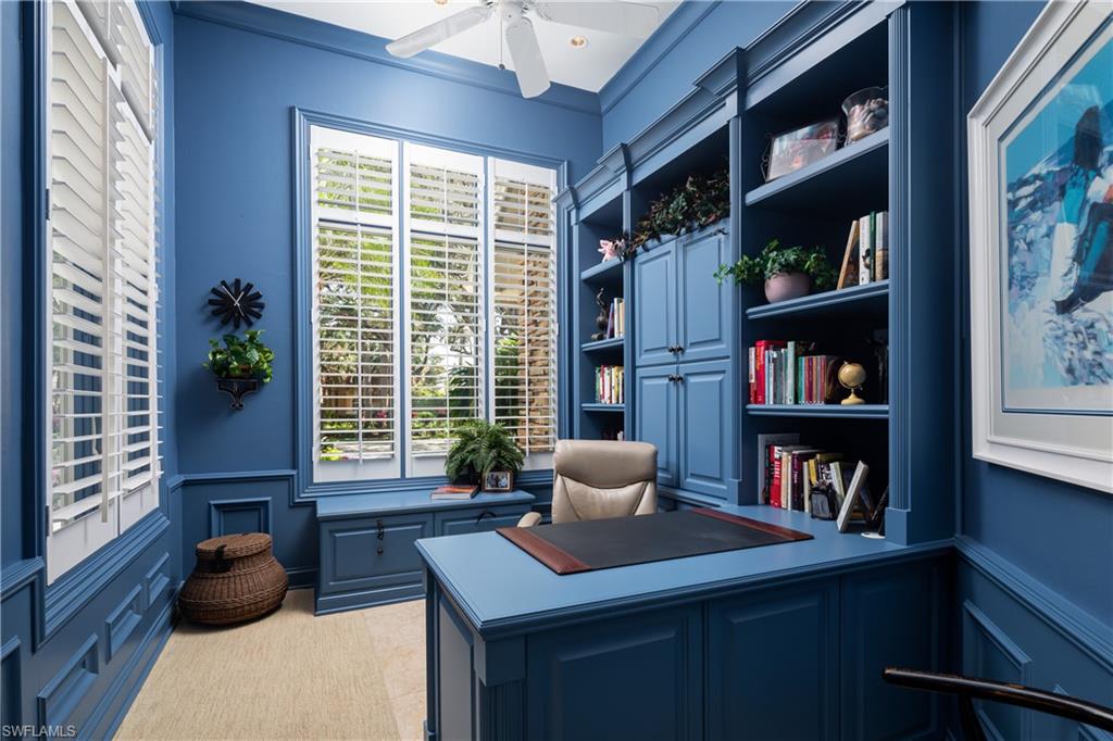 980 Barcarmil Way Naples, FL 34110 - Photo 20 of 50 a living room with furniture and a book shelf