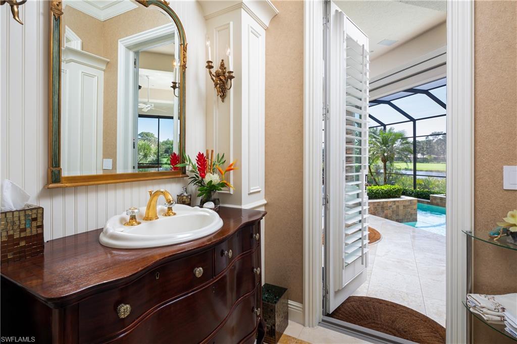 980 Barcarmil Way Naples, FL 34110 - Photo 21 of 50 a bathroom with a sink and a mirror