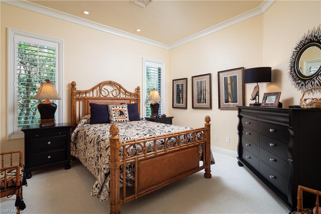 980 Barcarmil Way Naples, FL 34110 - Photo 22 of 50 a bedroom with a bed and a dresser