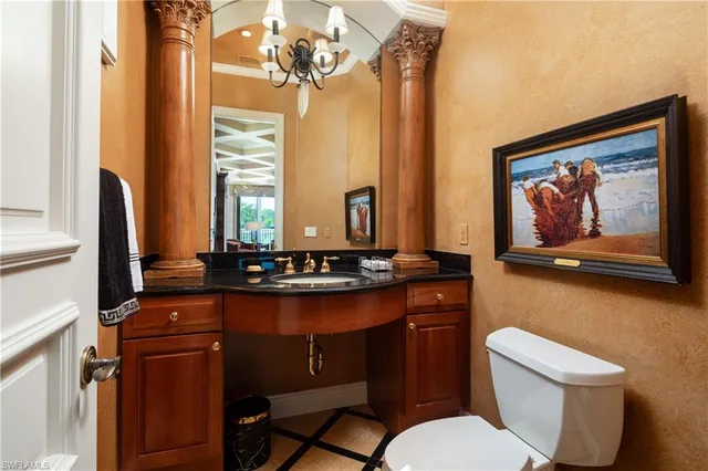 a bathroom with a toilet a sink and a mirror