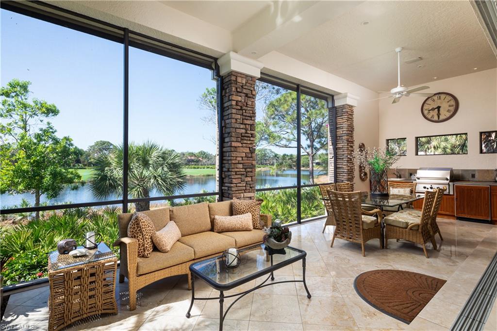 980 Barcarmil Way Naples, FL 34110 - Photo 3 of 50 a living room with furniture and a floor to ceiling window