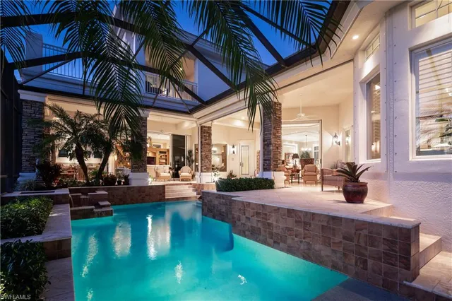 a living room with large windows and furniture