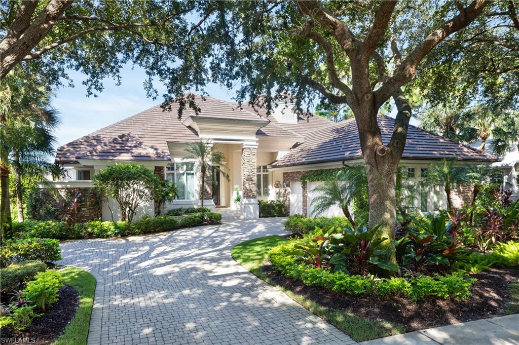 980 Barcarmil Way Naples, FL 34110 - Photo 40 of 50 a front view of a house with garden