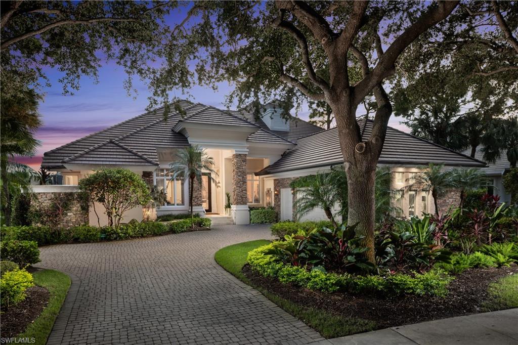 980 Barcarmil Way Naples, FL 34110 - Photo 4 of 50 a view of a house with a tree and flower plants