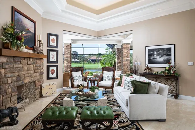a living room with fireplace furniture and a large window