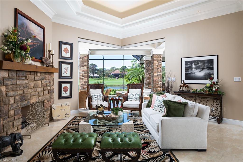 980 Barcarmil Way Naples, FL 34110 - Photo 5 of 50 a living room with fireplace furniture and a large window