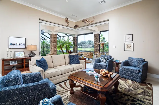 a living room with furniture a table and a large window