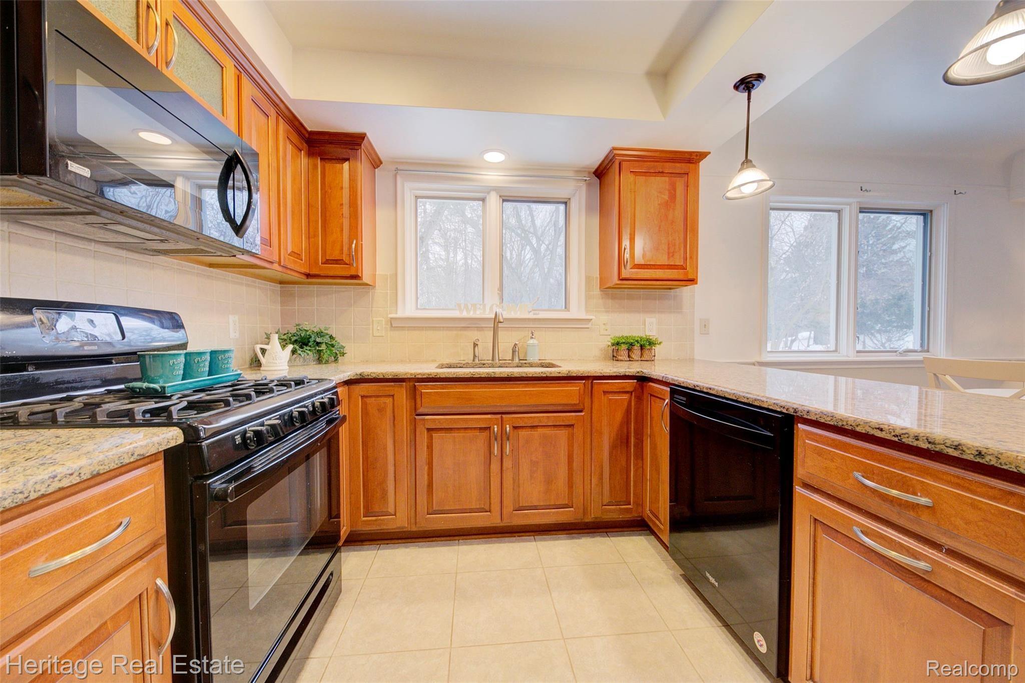 654 Old Perch Road Rochester, MI 48309 - Photo 19 of 61 This fabulous kitchen has built in pantry-cabinets, abundant cabinetry and counter top space, a desk area, and granite counter tops