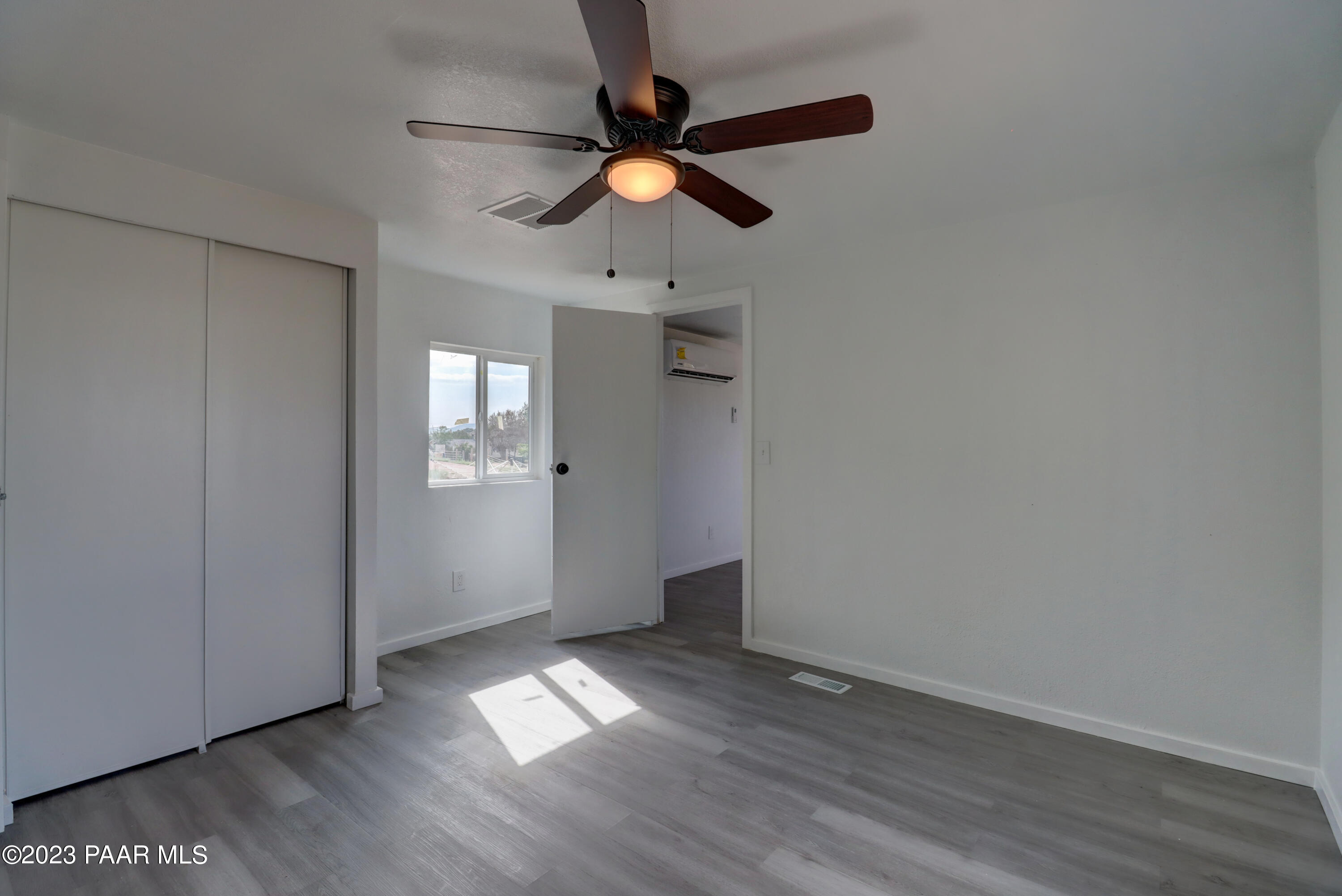 440 Antelope Run Road Paulden, AZ 86334 - Photo 13 of 24 wooden floor in an empty room with a window