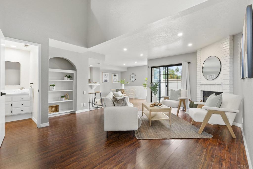 a living room with furniture wooden floor and a fireplace