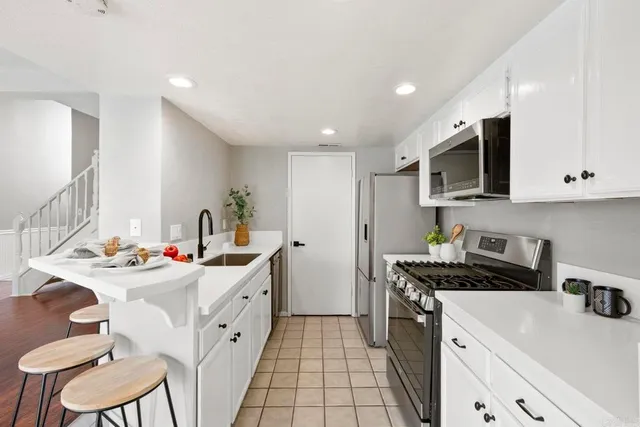 a kitchen with a sink stove and cabinets