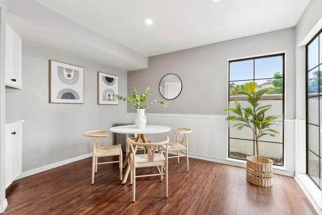 a view of a dining room with furniture window and wooden floor