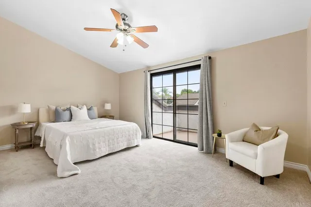 a spacious bedroom with a bed and a ceiling fan