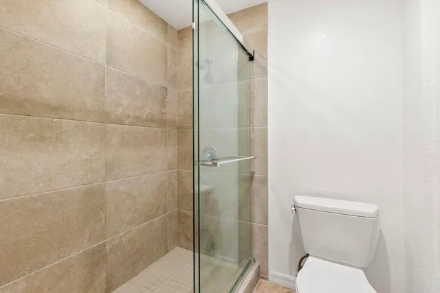 a bathroom with a toilet and a shower