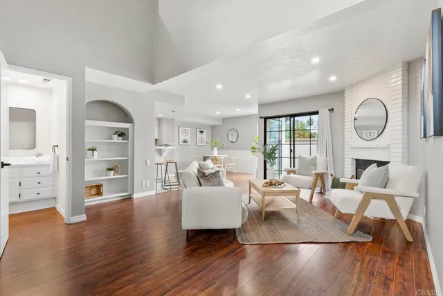 a living room with furniture wooden floor and a fireplace
