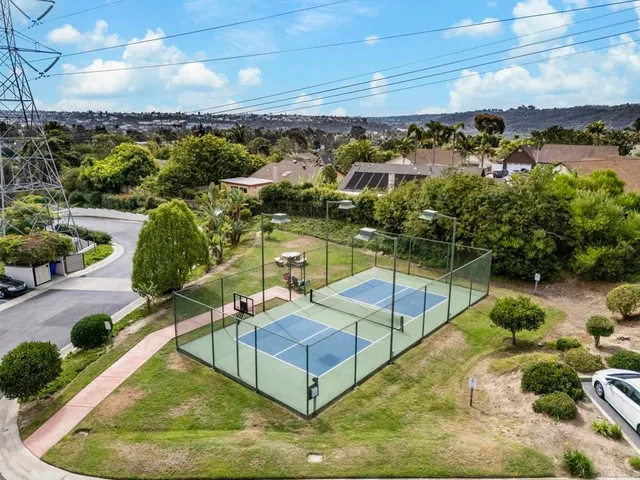 a view of a swimming pool with a patio and a yard