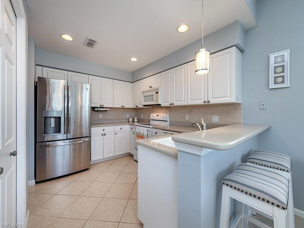 22911 Rosedale Drive, Unit 101 Estero, FL 34135 - Photo 5 of 15 Kitchen with breakfast bar