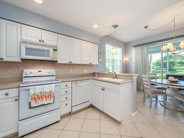 a kitchen with a stove window and cabinets