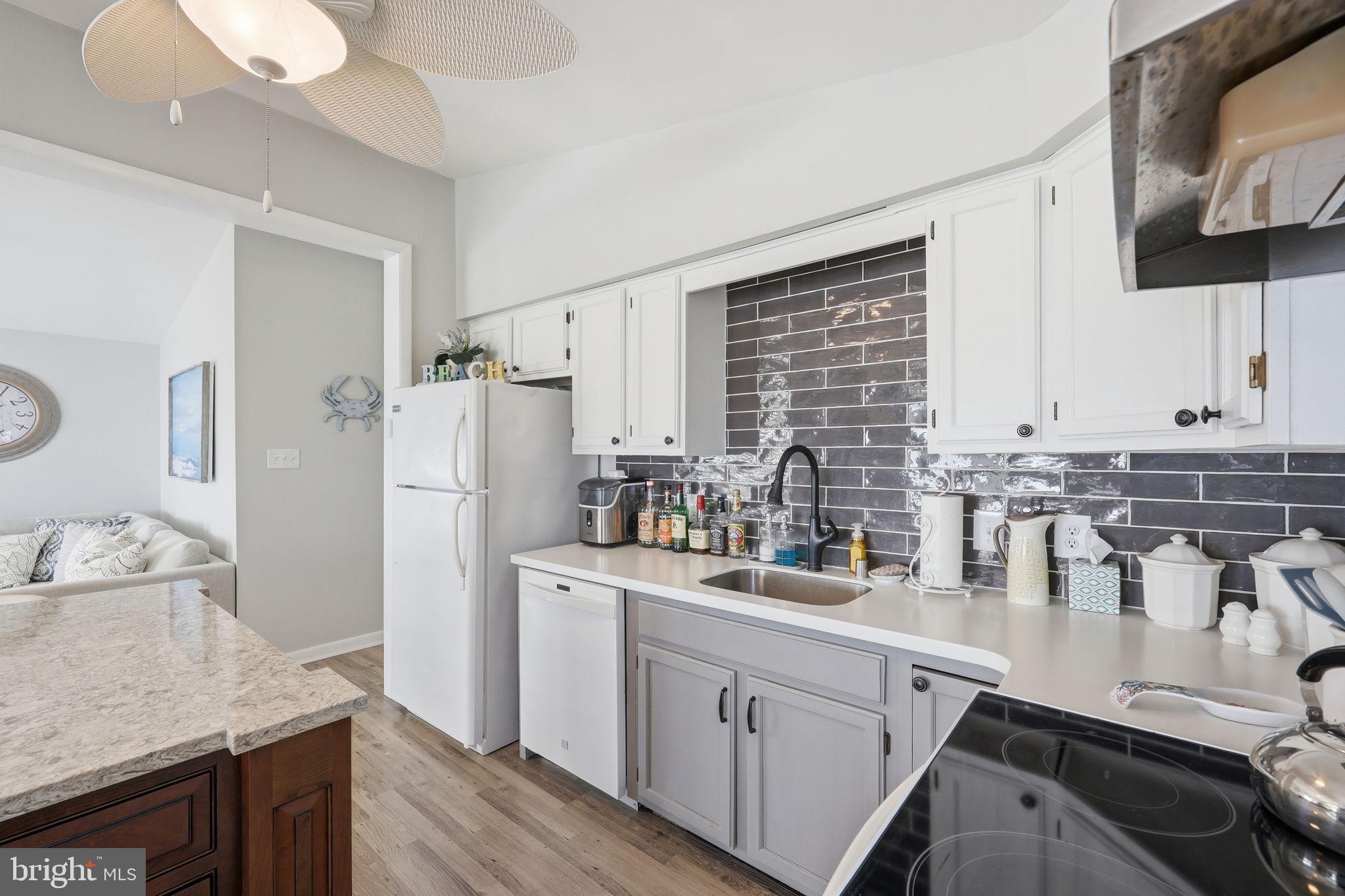 173 Cove Road Newport, NJ 08345 - Photo 15 of 72 a kitchen with a sink stove and refrigerator