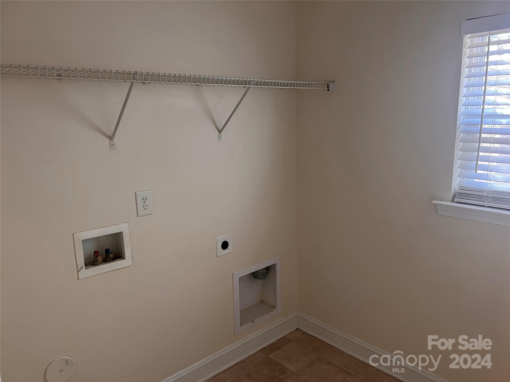 6706 Ferrell Commons Road Charlotte, NC 28269 - Photo 14 of 22 a view of a room with rack on the wall