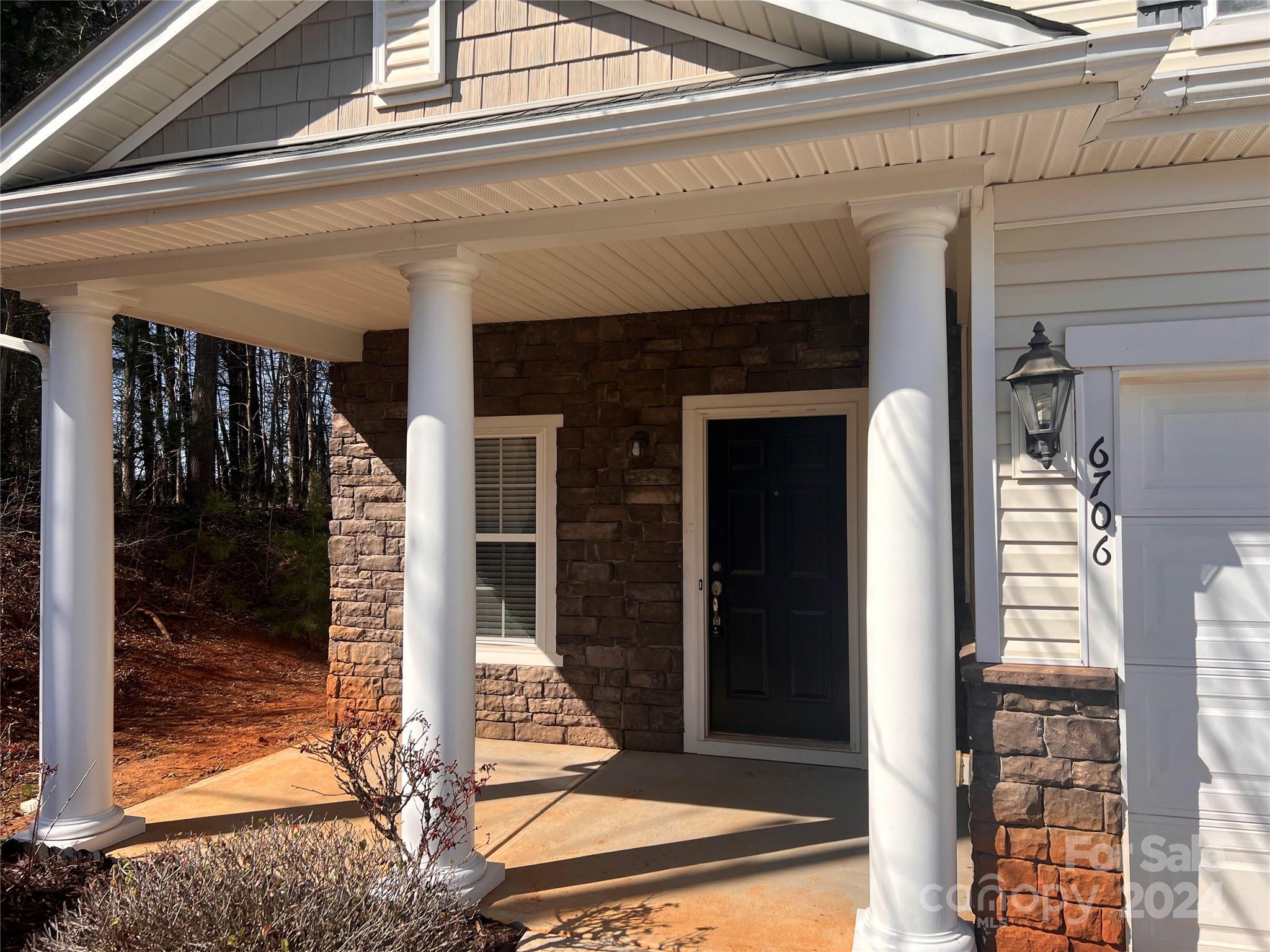 6706 Ferrell Commons Road Charlotte, NC 28269 - Photo 2 of 22 a front view of a house with a glass door
